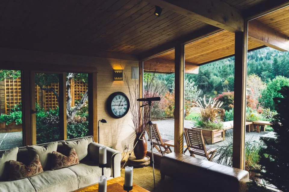 Covered veranda with a sofa, looking out to the garden
